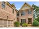 Charming brick home featuring an attached garage, landscaped front yard, and a welcoming entrance at 2750 Vinings Orchard Se Cir, Atlanta, GA 30339