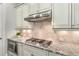 Gourmet kitchen with granite countertops, stainless steel appliances, and custom backsplash at 2750 Vinings Orchard Se Cir, Atlanta, GA 30339
