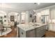 Open kitchen features a granite island with stainless steel appliances and hardwood floors at 2750 Vinings Orchard Se Cir, Atlanta, GA 30339