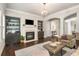 Cozy living room featuring a fireplace, custom built-ins, hardwood floors, and a neutral color palette at 2750 Vinings Orchard Se Cir, Atlanta, GA 30339