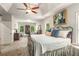 Large main bedroom with a sitting area, tray ceiling, and a ceiling fan at 2750 Vinings Orchard Se Cir, Atlanta, GA 30339