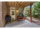 Covered patio area with brick columns, featuring an outdoor grill and seating area at 2750 Vinings Orchard Se Cir, Atlanta, GA 30339