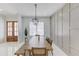 Bright dining room with a long wooden table and bench seating, decorative wall paneling, and modern lighting at 961 Nours Cir, Lawrenceville, GA 30045