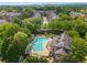 Aerial view of a neighborhood community pool with a glimpse of the city in the distance at 2314 English Ivy Se Ct, Atlanta, GA 30339