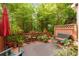 Secluded back deck surrounded by lush trees and various potted plants, ideal for relaxing at 2314 English Ivy Se Ct, Atlanta, GA 30339