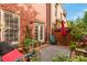 Charming back patio featuring a brick wall, outdoor seating, and a variety of potted plants at 2314 English Ivy Se Ct, Atlanta, GA 30339