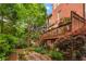 Picturesque backyard featuring a spacious deck, stone pathway, and mature landscaping, offering a serene outdoor retreat at 2314 English Ivy Se Ct, Atlanta, GA 30339