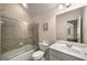 Bathroom featuring a shower/tub combo with sliding doors, a clean vanity, and neutral wall paint at 2314 English Ivy Se Ct, Atlanta, GA 30339