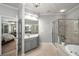 Well-lit bathroom featuring a glass-enclosed shower, soaking tub, and access to the main bedroom at 2314 English Ivy Se Ct, Atlanta, GA 30339