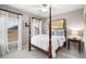 Comfortable bedroom with four-poster bed, light-filled windows, and neutral tones that create a serene atmosphere at 2314 English Ivy Se Ct, Atlanta, GA 30339