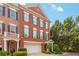 Charming brick townhome with two-car garage, manicured landscaping, and beautiful architectural details at 2314 English Ivy Se Ct, Atlanta, GA 30339