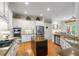 Modern kitchen featuring white cabinets, granite countertops, and stainless steel appliances at 2314 English Ivy Se Ct, Atlanta, GA 30339