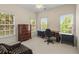Bright office space with multiple windows, classic furnishings, and a cozy armchair for relaxation at 2314 English Ivy Se Ct, Atlanta, GA 30339