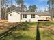 Exterior back view of home featuring a deck, large yard, and new siding at 70 Wall St, Hampton, GA 30228
