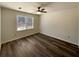 Bright bedroom featuring a ceiling fan and a large window at 70 Wall St, Hampton, GA 30228
