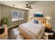 Staged bedroom featuring a ceiling fan, a large window, and minimalist decor at 70 Wall St, Hampton, GA 30228