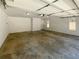 Spacious garage with white brick accent wall, overhead lighting, and ample room for parking and storage at 70 Wall St, Hampton, GA 30228