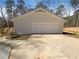 A one-story home featuring a white garage, concrete driveway, and a wooden deck with steps at 70 Wall St, Hampton, GA 30228