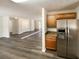 Bright kitchen features stainless steel refrigerator and wood cabinets with updated hardware at 70 Wall St, Hampton, GA 30228