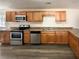 Kitchen featuring stainless steel appliances and wooden cabinetry at 70 Wall St, Hampton, GA 30228