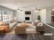 Bright, staged living room featuring a fireplace, ceiling fans, and large windows at 70 Wall St, Hampton, GA 30228