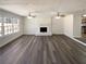 Bright living room with a fireplace, ceiling fans, and large windows at 70 Wall St, Hampton, GA 30228