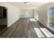 Sunlit living room featuring new floors and windows with outdoor views at 70 Wall St, Hampton, GA 30228