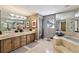 Elegant bathroom with double sink, tub, and large mirror reflecting space at 935 Pine Grove Pointe Dr, Roswell, GA 30075