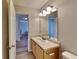 Well-lit bathroom with wood cabinets, an oval sink, and a mirror at 955 Magnolia Gardens Walk, Mcdonough, GA 30253