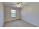 Bright bedroom featuring neutral carpet and a window providing natural light at 955 Magnolia Gardens Walk, Mcdonough, GA 30253