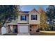 Charming two-story townhome featuring a one-car garage and well-maintained front lawn at 955 Magnolia Gardens Walk, Mcdonough, GA 30253