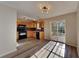 Well-lit kitchen featuring wood cabinets, black appliances, and access to the backyard at 955 Magnolia Gardens Walk, Mcdonough, GA 30253