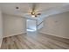 Bright living room with hardwood floors, a ceiling fan, and access to the stairway at 955 Magnolia Gardens Walk, Mcdonough, GA 30253