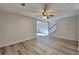 Open-concept living room with hardwood floors, neutral walls, and a ceiling fan at 955 Magnolia Gardens Walk, Mcdonough, GA 30253