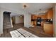 Spacious living room with hardwood floors, and a view of the stairs and kitchen at 955 Magnolia Gardens Walk, Mcdonough, GA 30253