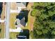 An aerial view of a well-manicured lawn and mature trees surrounding a charming brick house with a spacious driveway at 1368 Fall River Dr, Conyers, GA 30013