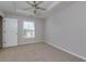 Bedroom featuring carpeted floors, a ceiling fan, and window at 1368 Fall River Dr, Conyers, GA 30013