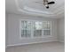 Bright bedroom with tray ceilings, neutral paint and large windows at 1368 Fall River Dr, Conyers, GA 30013