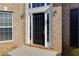 Elegant black front door with sidelights and brick surround at 1368 Fall River Dr, Conyers, GA 30013