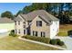 Aerial view of a charming two-story home with brick facade and landscaped yard at 1368 Fall River Dr, Conyers, GA 30013