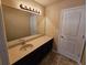 Bathroom with large mirror and sink vanity with dark wood cabinets at 203 August West Way, Lawrenceville, GA 30046