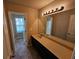 Bathroom with double sink vanity, large mirror, and a shower at 203 August West Way, Lawrenceville, GA 30046