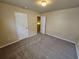 Bedroom with neutral walls, carpet and two white doors at 203 August West Way, Lawrenceville, GA 30046