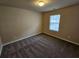 Bedroom with neutral walls, carpet and single window at 203 August West Way, Lawrenceville, GA 30046