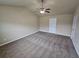 Carpeted bedroom with a ceiling fan and a door for easy access at 203 August West Way, Lawrenceville, GA 30046