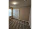 Bedroom with carpet, neutral walls, window, and a double door closet at 203 August West Way, Lawrenceville, GA 30046