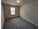 Bedroom featuring neutral walls, carpet, and a window at 203 August West Way, Lawrenceville, GA 30046