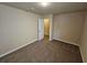 Bedroom featuring neutral walls, carpet, and white door to hallway at 203 August West Way, Lawrenceville, GA 30046