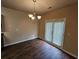 Open concept dining room featuring wood floors and double doors that offer backyard access at 203 August West Way, Lawrenceville, GA 30046