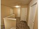 Upstairs hallway features neutral walls and carpet and multiple white doors at 203 August West Way, Lawrenceville, GA 30046